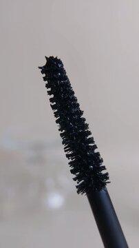 Close up of mascara brush for eyelashes. Beauty applicator tool, bristle texture for eye makeup.