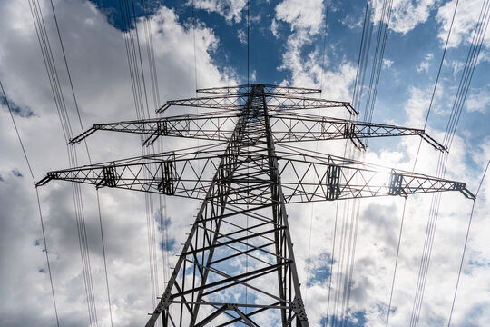 Electric voltage station. High voltage. Electricity power pylon. Electricity tower. Electrical energy. Power transmission tower. Electricity power lines and sky. Green energy