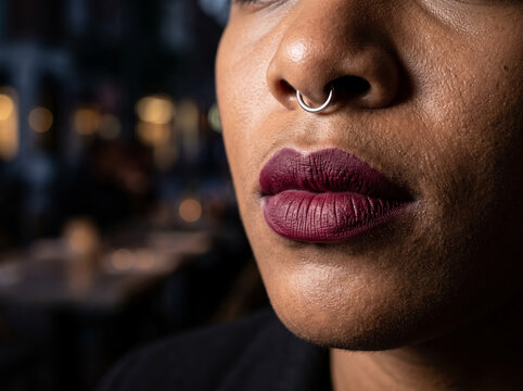 Close Up Profile Shot of Woman with Nose Septum Piercing and Dark Lips