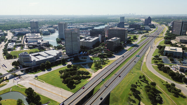 Las Colinas APT guideways parallel extensive commuter paths across industrial zones. Elevated tracks depict automated infrastructure systems supporting corporate travel demands, Irving, TX
