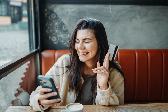 Woman buying online using phone and credit card