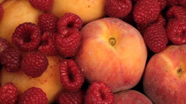 Healthy vegan snack. Mix fruits and berries apricot, peach, raspberry close up, rotation