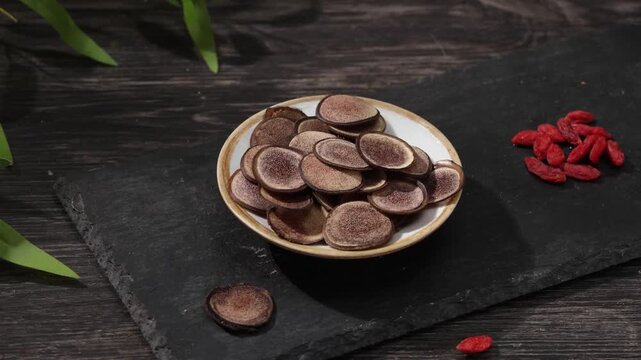 Traditional Chinese Medicine Velvet Antler Slices on Dark Wooden Table