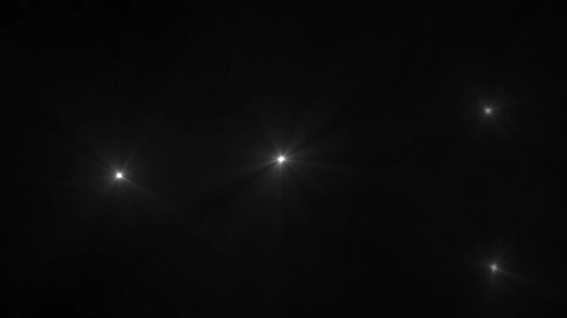 Camera flashes Lights black background. white camera flashes random black screen.Flashing lens flares.
 Seamless looping.loopable motion graphic video.Camera Flashes at a stadium concert.