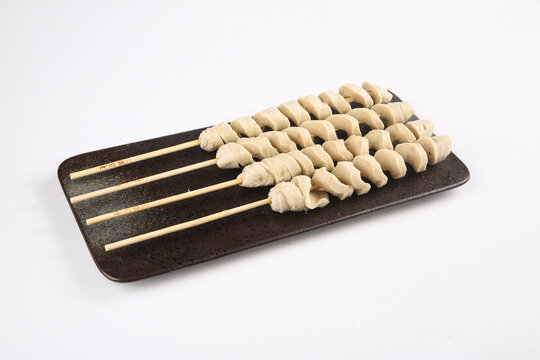 Henan Style Homemade Gluten Skewers on Dark Plate - Traditional Chinese Food Preparation
