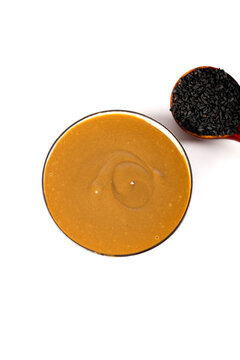 Pure sesame sauce with black sesame seeds - traditional Asian dipping sauce condiment