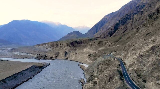 Scenic drone flight along a mountain river with a winding road in Chitral Pakistan