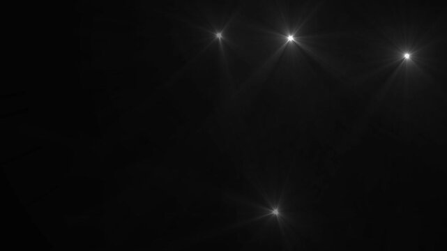 Camera flashes Lights black background. white camera flashes random black screen.Flashing lens flares.
 Seamless looping.loopable motion graphic video.Camera Flashes at a stadium concert.