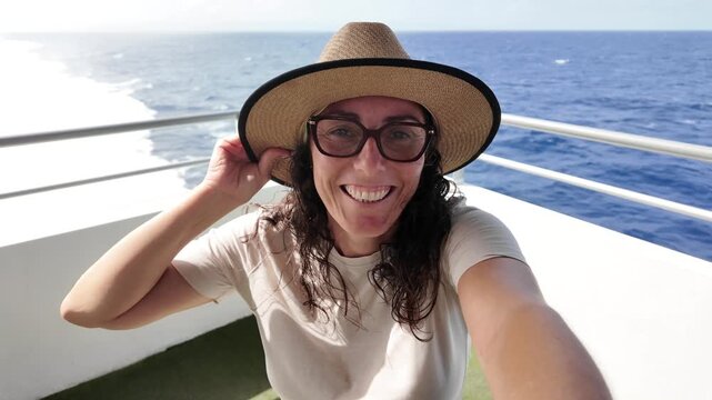 Woman recording selfie travel vlog on ferry deck