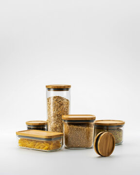 Assortment of glass food storage containers with bamboo lids filled with dry goods image photo