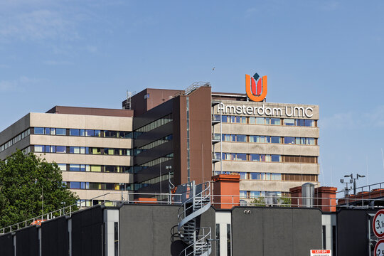 Amsterdam, Netherlands, May 23, 2026. The exterior facade of the Amsterdam UMC university medical center hospital building featuring its prominent orange logo under a clear sky.