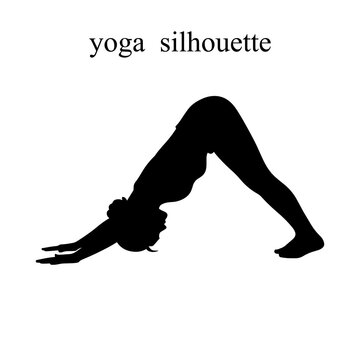 Person practicing downward dog yoga pose silhouette