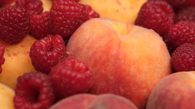 Mix fruits and berries apricot, peach, raspberry close up, rotation