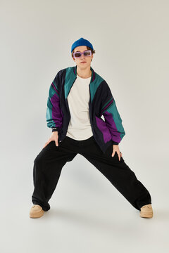 A handsome young man embodies youth culture while showcasing a trendy bomber jacket.