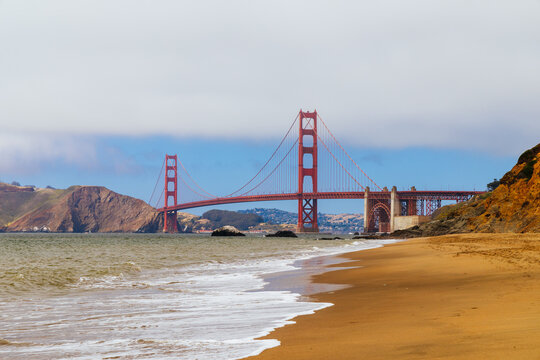 Iconic Golden Gate Bridge vista from Bakers Beach San Francisco California USA on a cloudy day