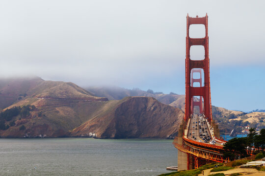 Golden Gate Bridge traffic on a foggy day view from Baker Beach San Francisco California USA