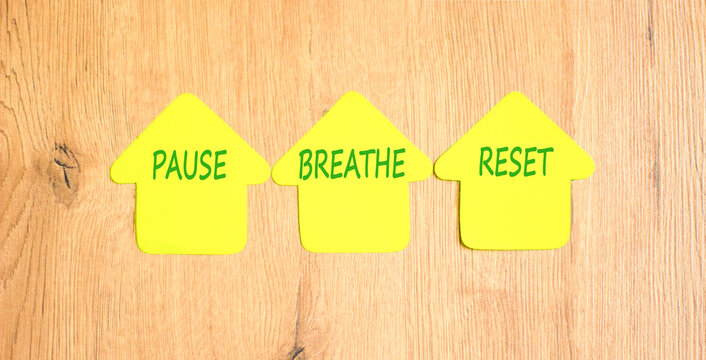 Pause breathe reset symbol. Concept words Pause breathe reset on beautiful yellow paper houses. Beautiful wooden background. Business support motivational and pause breathe reset concept. Copy space.