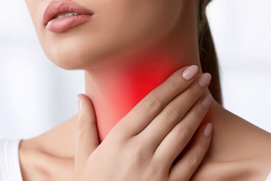 Woman touches neck to thyroid gland disease symptoms. Glowing red sign on throat. Endocrine inflammation hypothyroidism goiter node or larynx pain. Lymph node screening, hormones. Awareness campaign