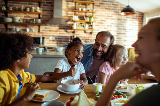 Family eating breakfast together at home kitchen