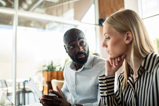 Two business colleagues discussing project in modern office