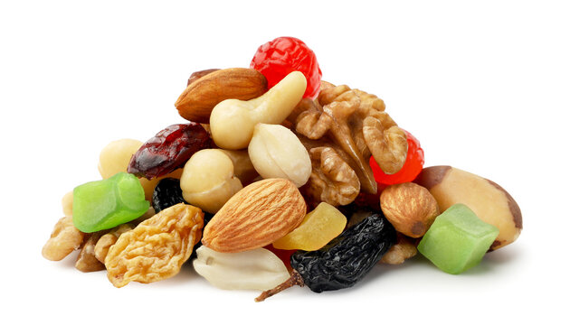 Heap of mixed nuts and dried fruits close-up on a white background. Isolated