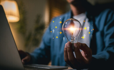 Man Hands holding light bulb for Concept new idea concept , Idea innovation and inspiration new idea and innovation with energy and power © A Stockphoto