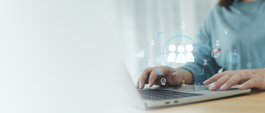 Women uses a laptop to target and select key personnel using digital technology. The image conveys an HR strategy focused on finding the right employees to drive the organization towards future