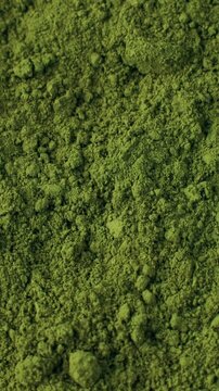Matcha green tea powder circle rotation. Moringa, Spirulina, chlorella superfoods, vertical video format