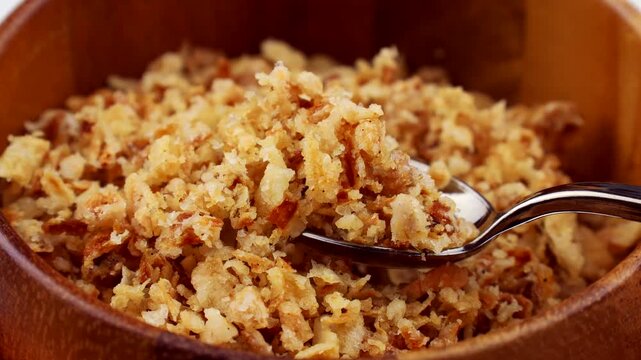 Organic crispy fried onions taking with a spoon close up