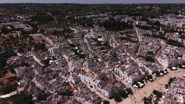 Scenic aerial view of the historic trulli houses of alberobello, puglia, showing the unique conical roofs and whitewashed walls of this famous unesco world heritage site