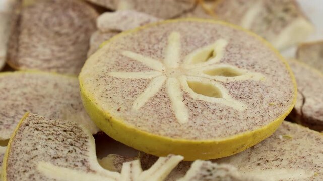 Yellow freeze dried persimmon slices texture circle rotation close up