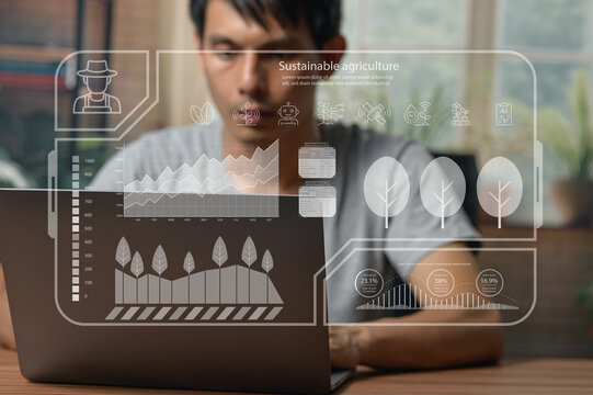 Young Man Analyzing Sustainable Agriculture Data Using Digital Technology in Office