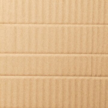 flat lay background of natural light brown corrugated cardboard
