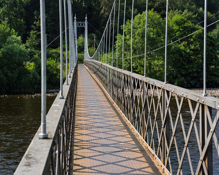 Victoria Bridge also known as the Penny Bridge crossing over the River Spey near Aberlour in Moray Scotland during a bright summer day