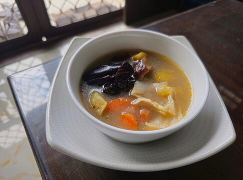 vegetable soup with meat,The bird nest soup,Indonesian called Sup sarang burung walet made from The Swiftlet nest,healthy food from Chinese tradition.Warm soup with vegetables in a white bowl. 