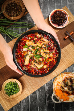 Spicy Blackened Fish Fillet with Red Chili Peppers and Oil - Traditional Chinese Sichuan Cuisine Hot Pot Dish