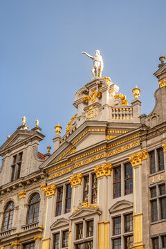 Ornate historic guild house crowned with a gilded statue overlooking the Grand Place.