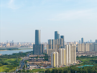 Fototapeta premium A panoramic aerial view of modern skyscrapers and urban architecture along the river in Nanchang City located in Jiangxi province of China during a clear day
