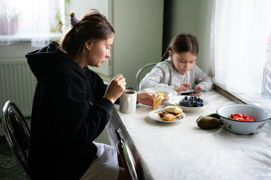 Mother and daughter sharing breakfast. Quiet, cozy moment. A serene start to the day at the breakfast table in a comforting atmosphere.