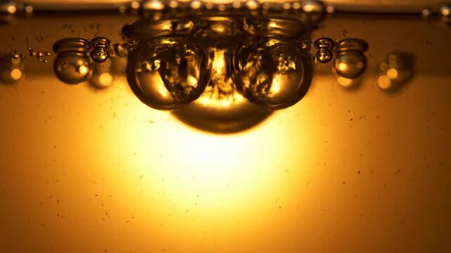 Bubbles rising in warm liquid in a glass setting with a glowing light effect