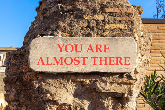 You are almost there symbol. Concept words You are almost there on beautiful white sign plate. Beautiful brick wall background. Business You are almost there motivational support concept. Copy space
