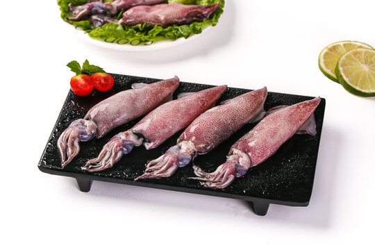 Fresh Raw Squid Seafood on Black Plate with Tomatoes and Lime - Shandong Delicious Aquatic Food