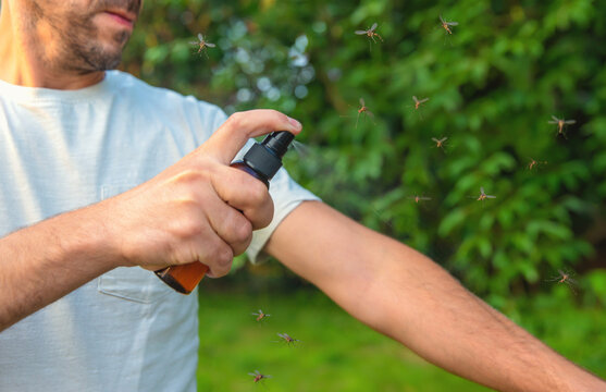 Mosquito repellent spray outdoors. Selective focus.