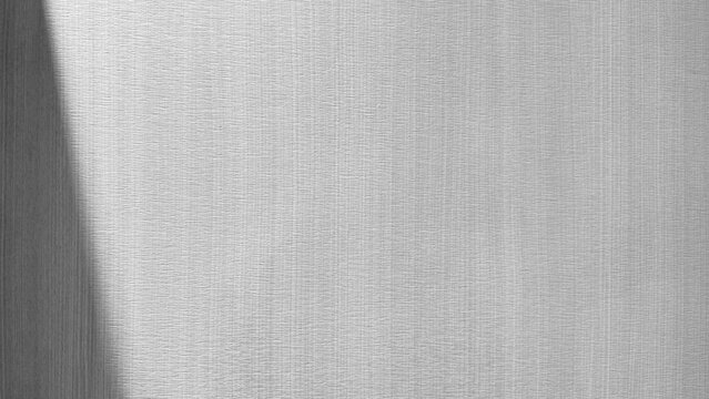 Light grey textured paper wallpaper background with subtle diagonal side shadow clean minimalist surface copy space top view closeup studio setting for interior design template frame.