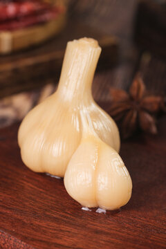 Fresh Peeled Garlic Bulbs and Cloves on Wooden Table - Cooking Ingredients