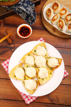 Chinese Dumplings and Thin Pancakes with Sauce - Traditional Shandong Gourmet Food on Wooden Table