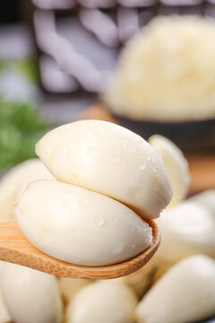 Fresh White Garlic Cloves from Chinese Provinces - Henan Yunnan Shandong Traditional Agricultural Produce on Wooden Spoon
