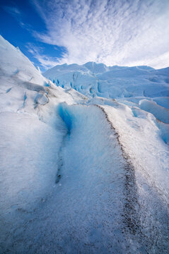 Perito moreno glacier landscape showing climate change impact and serene atmosphere with awe inspiring blue ice formation reflecting majestic frozen nature environment bright clear sky outdoor