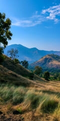 Fototapeta premium Scenic Landscape with Rolling Hills and Blue Sky: Breathtaking View of Nature's Beauty