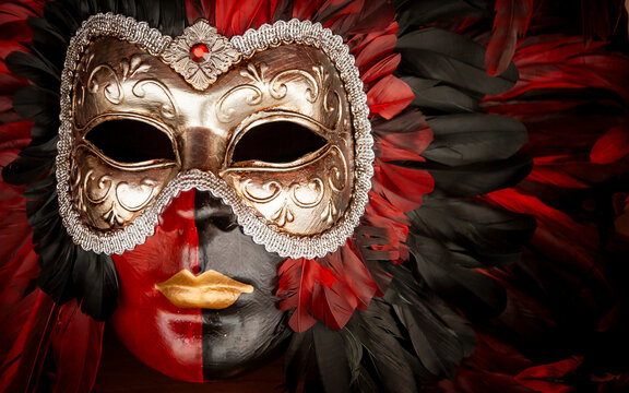 Carnival mask Venice. Traditional ornate gold and red feathered disguise for Venetian masquerade party.